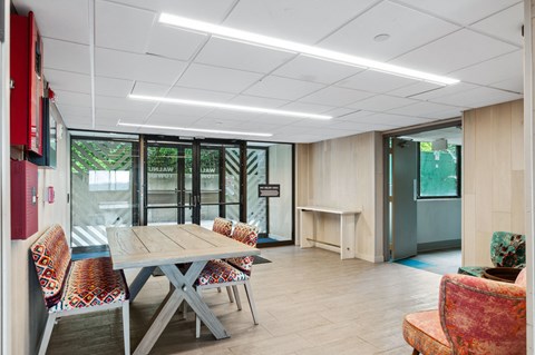 a meeting room with a wooden table and chairs